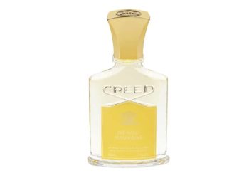 Frasco de perfume de cristal con etiqueta y tapón amarillos Creed Neroli Sauvage